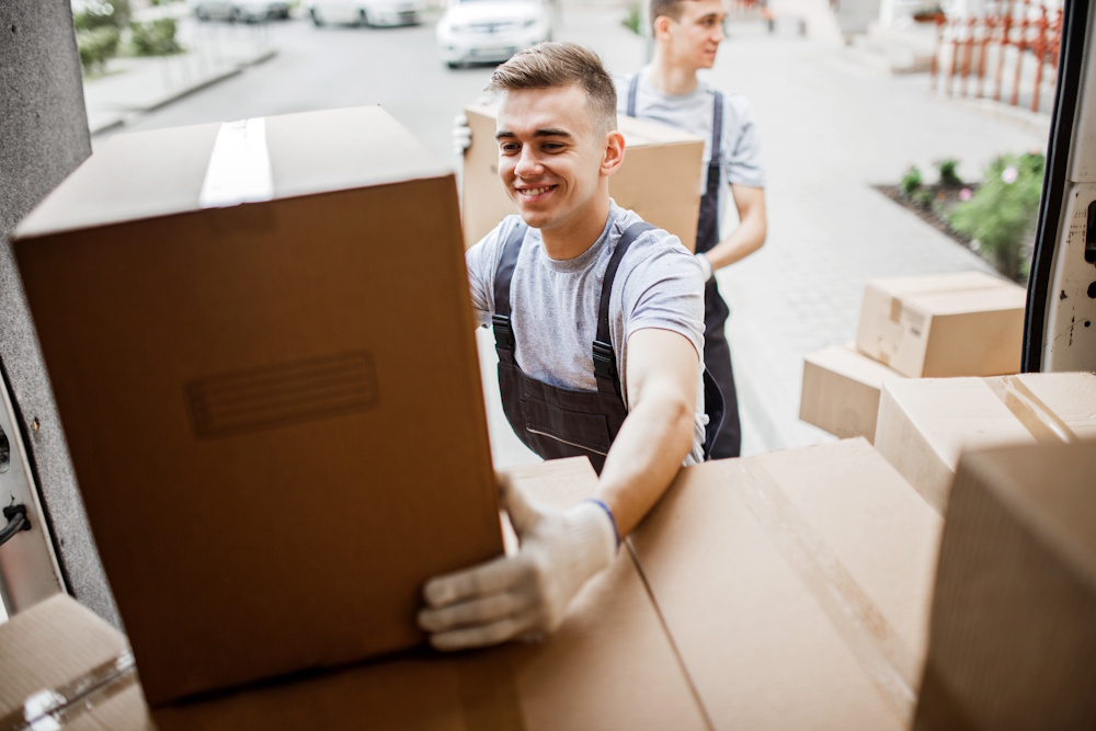 movers putting boxes on truck